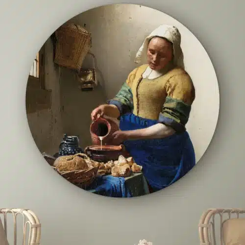 Muurcirkel Het melkmeisje van Johannes Vermeer aan de muur boven twee rotan stoelen