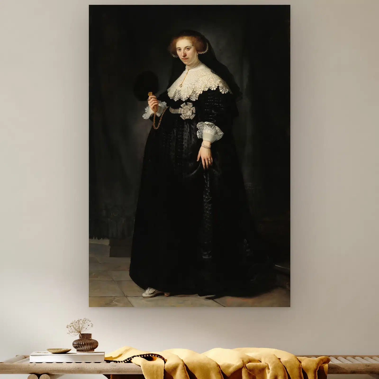 Portret van Oopjen Coppit van Rembrandt van Rijn aan de muur boven een houten bank met een okergele plaid