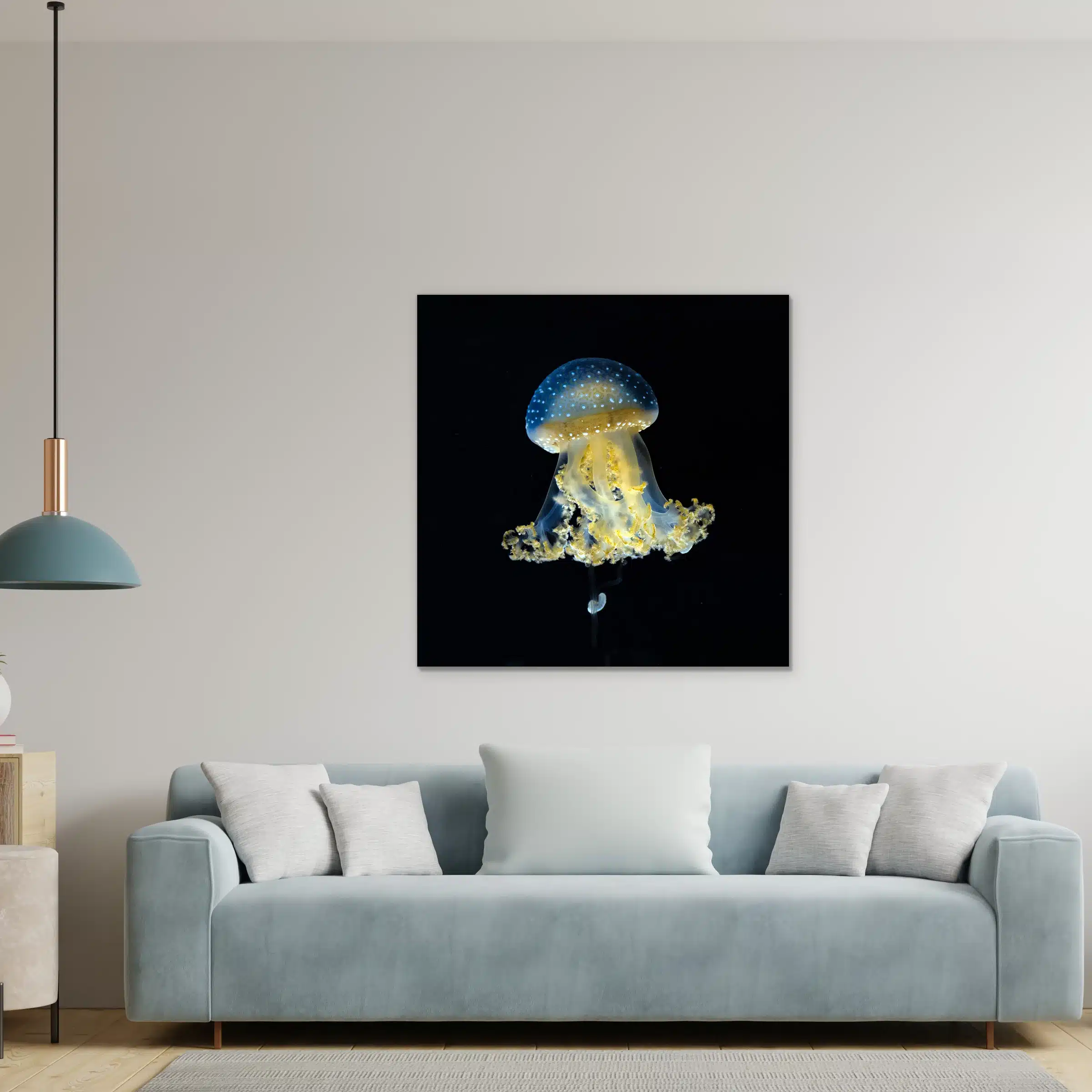 Kwal Yanga wanddecoratie aan de muur boven een lichtblauwe bank met een hanglamp