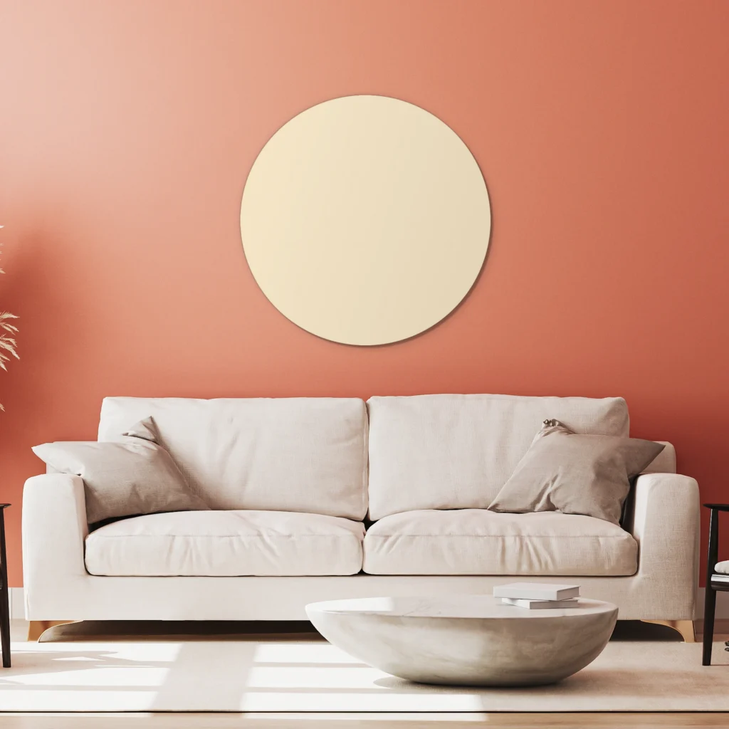 Muurcirkel beige aan een koraalrode wand boven een witte bank