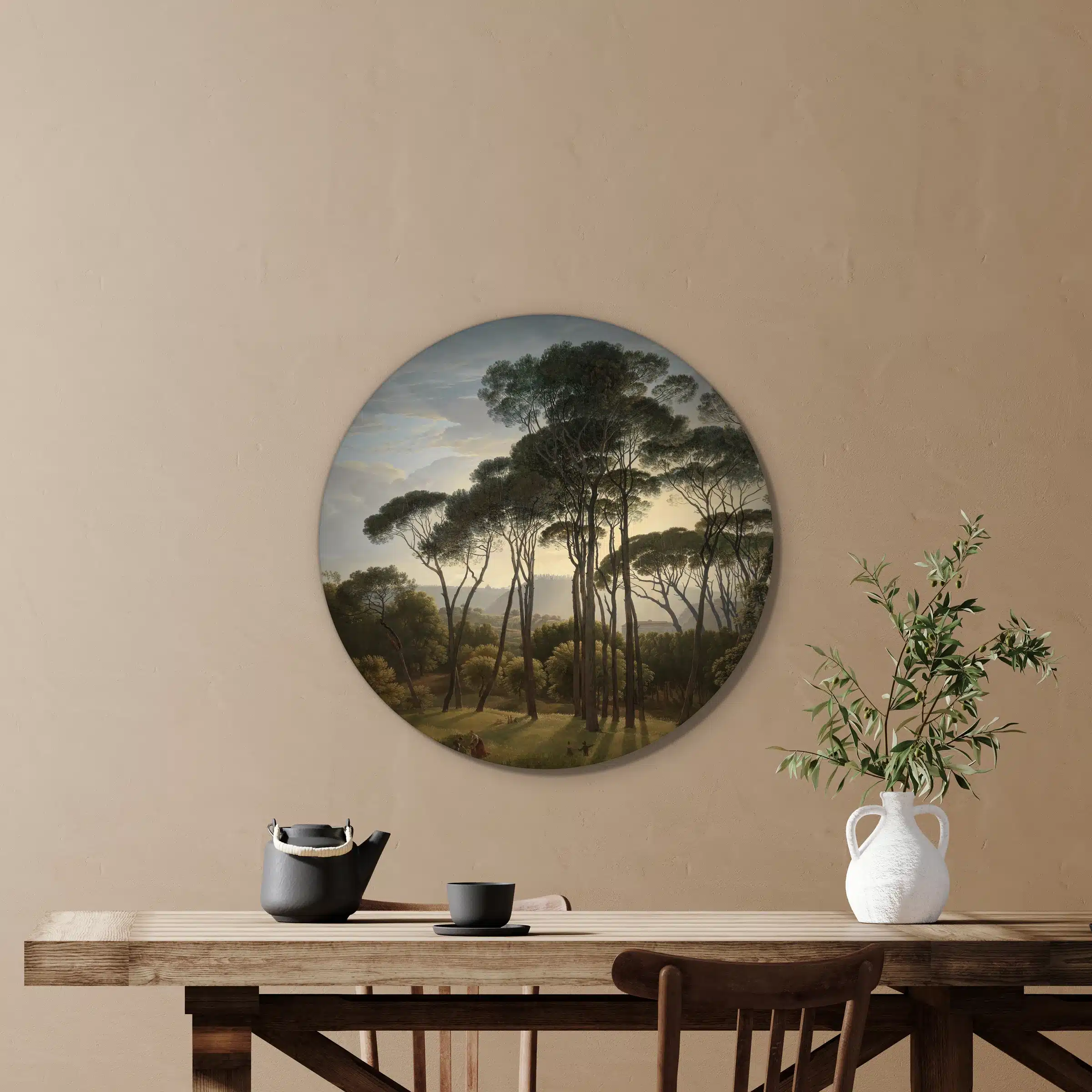 Italiaans landschap met parasoldennen van Hendrik Voogd als muurcirkel boven een houten tafel met een olijftak