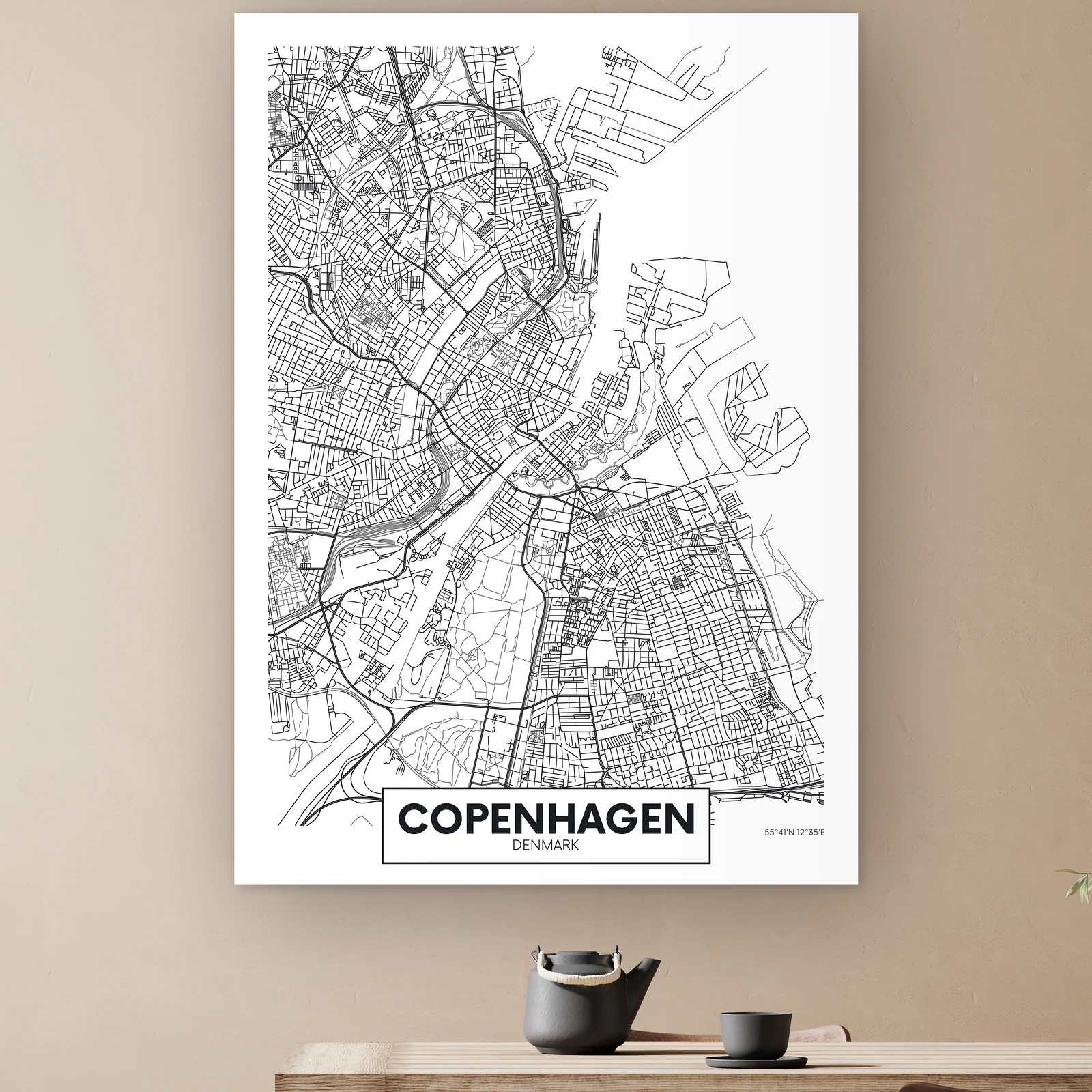 Plattegrond Kopenhagen aan de muur boven een houten tafel met theepot