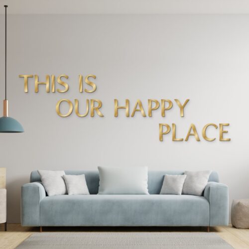 This is our happy place in goud geborsteld aluminium aan de muur boven een bank